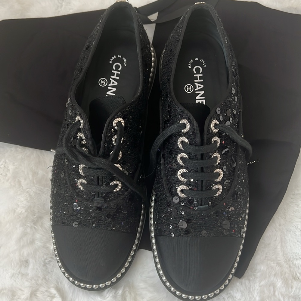 CHANEL Black low top sneakers with Pearl Trim and Gold Logo.